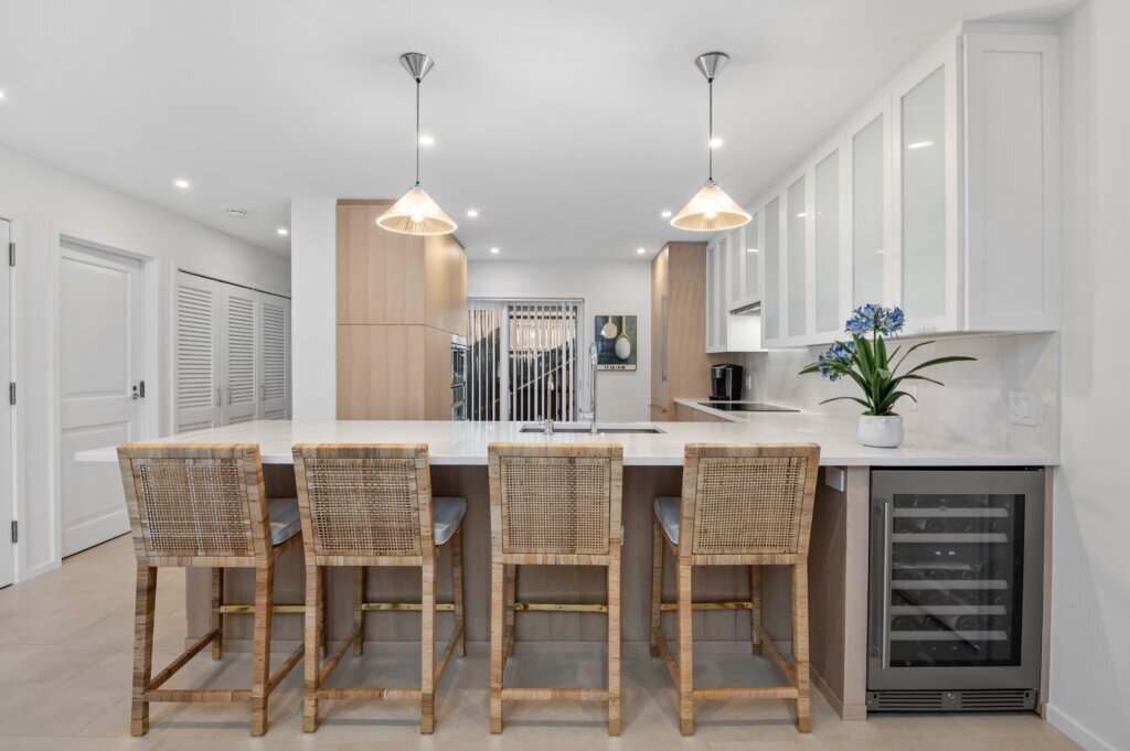 custom luxury kitchen with breakfast peninsula and wine refrigerator