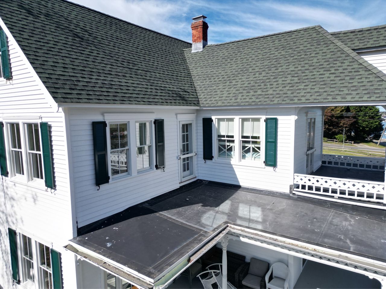 green custom shutters on white house